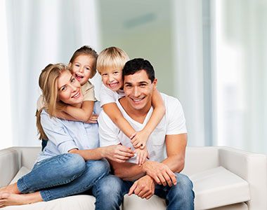 RJ-Landing-Image-2 A family sitting on a sofa