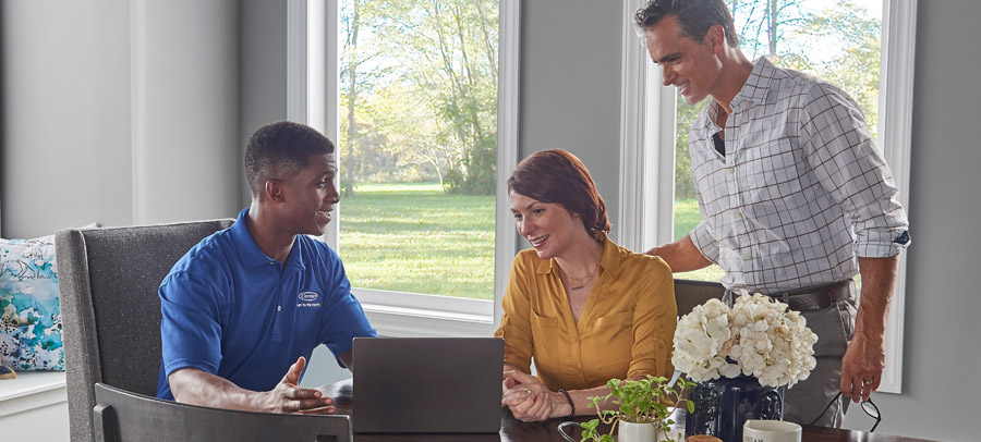 rj-boiler-install Technician with homeowners discussing benefits of a boiler installation