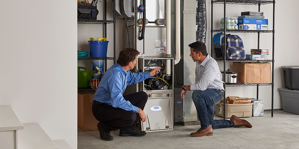 Male homeowner greets service tech for furnace repair in Milwaukee.